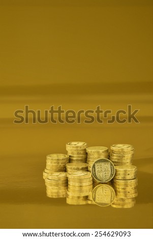 british one pound coins on gold background