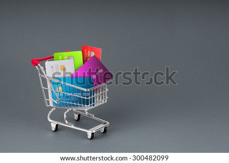 A selection off credit cards,bank cards and store cards in a shopping Trolley