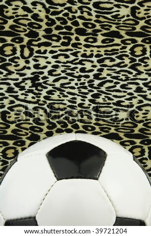 White leather football with leopard print in the background,