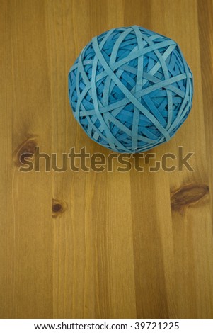 Elevated View of a blue Rubber Band ball on a wooden table