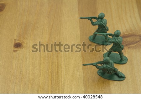 Close up shot of Plastic Toy Soldiers on a Wooden Table,