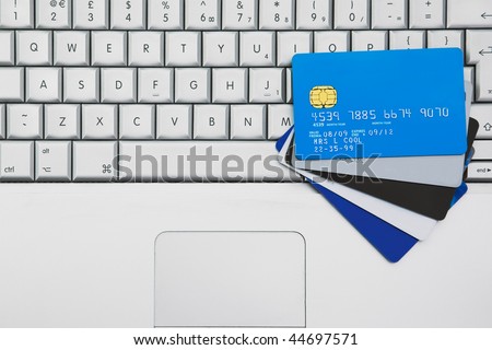 A Group off credit cards and bank cards on a Mobile Computer laptop keyboard