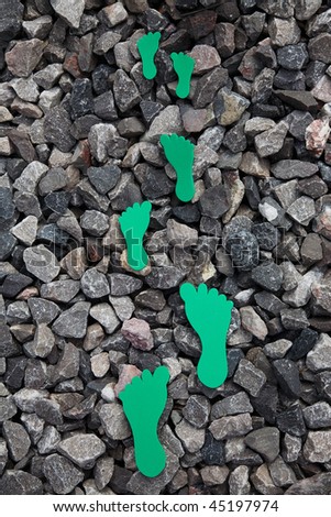 green foam feet on gravel to show Carbon footprint