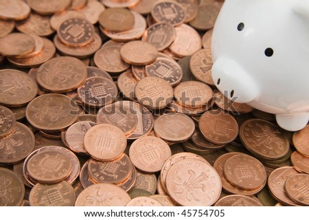Bank of england One and Two Pence Coins with white piggy bank in right top corner of image