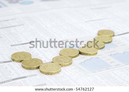 Financial Chart made out of British Coins Positioned  on a News paper financial page showing stocks and shares