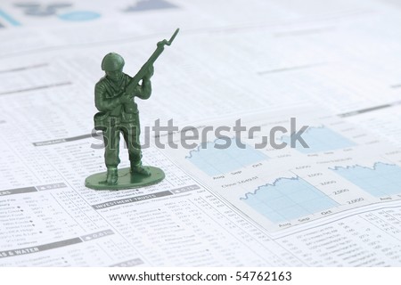 Small Toy solder on a News paper Stock market financial page showing stocks and shares