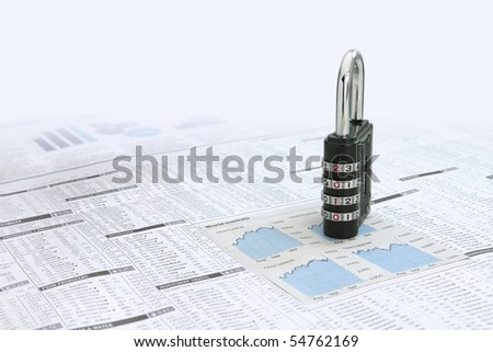 Combination padLock with the Year 2010 as the combination numbers News on a  paper financial page showing stocks and shares