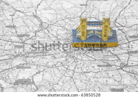 small model of Tower Bridge on top of a Map of london