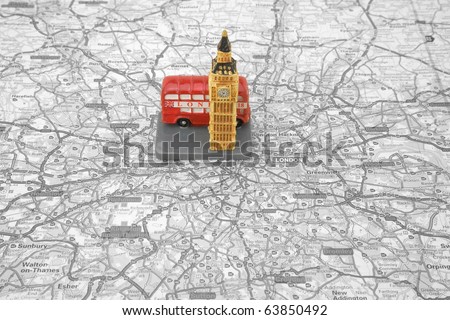 Small Model of a Red Bus and Big Ben on top of a Map of london