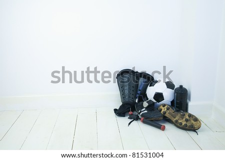 Football equipment in the corner of a empty room