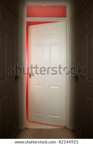 Slightly opened bedroom door with red light coming through