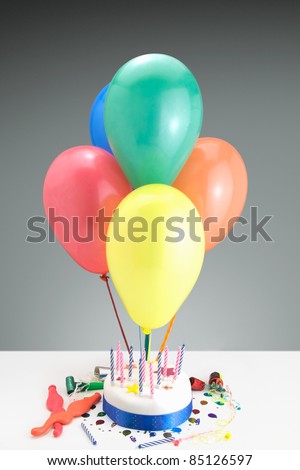 Party concept showing a Birthday cake,candles,balloons and party decorations