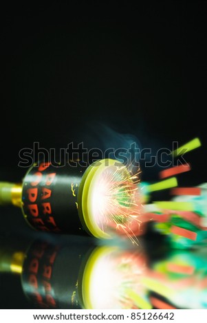 Close up shot of a Party Popper popping with sparks and streamers shooting out
