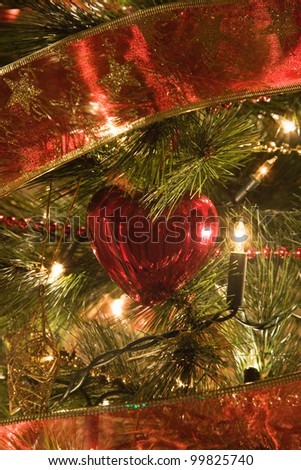 close up of Christmas heart shape tree decoration on a illuminated Christmas tree