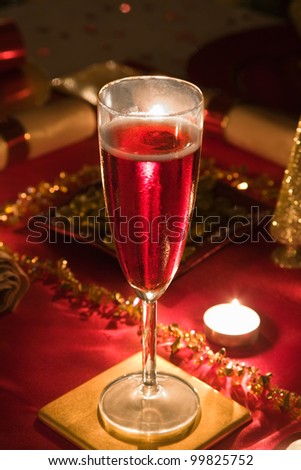 A Glass of Rose Champagne on a decorated Christmas day dinner table