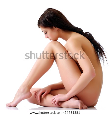stock photo The naked brunette girl with a lowered head on a white 