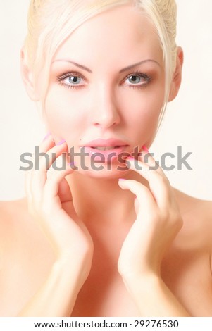 Portrait of the beautiful young woman with well-groomed hands at the person