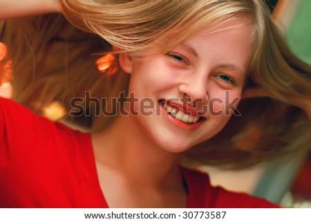 Portrait of the beautiful happy young girl of the blonde with an open smile