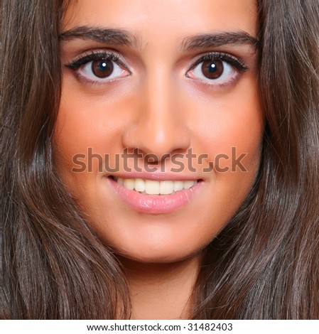 Portrait of the beautiful young woman with magnificent hair and with an open smile