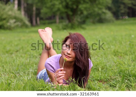 Portrait of the beautiful young girl in the spring in park