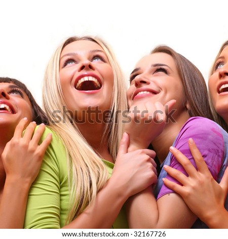 Four beautiful happy young women with a smile in bright multi-coloured clothes look upwards, isolated on a white background, please see some of my other parts of a images