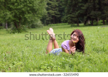 Portrait of the beautiful young girl in the spring in park