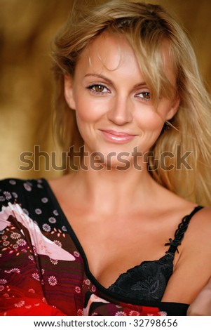 Portrait of the young beautiful woman with huge attracting eyes and with magnificent light hair