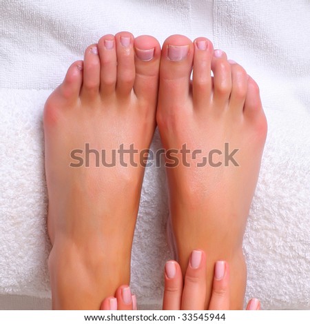 Well-groomed feet of female feet on a white towel