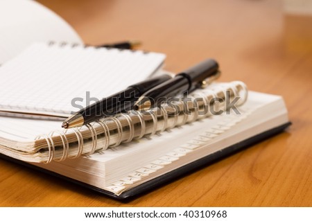 Opened address books, focused on top of pencil