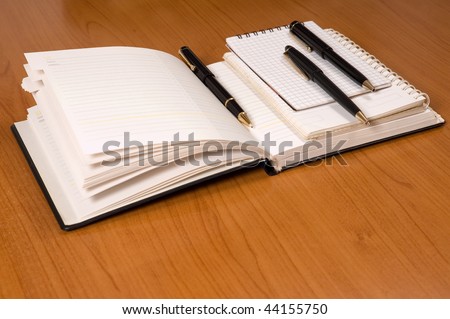 Opened address books with pencils