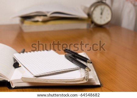 Opened address books, focused on top of the pencil