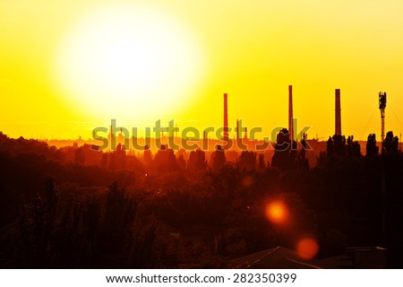 Sunny sunset view of the city. Yellow bright sun light, beautiful panorama.