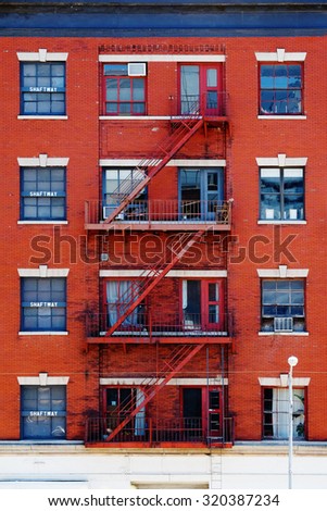 Fire ladders at beautiful colorful house facades in New York. Manhattan New York City - Background texture pattern of Buildings.