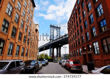Manhattan bridge seen from a brick buildings in Brooklyn street in perspective, New York, USA