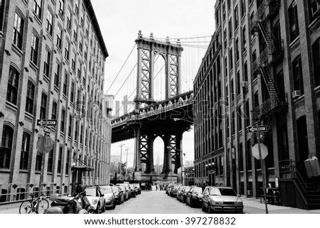 Manhattan bridge seen from a brick buildings in Brooklyn street in perspective, New York, USA. Business and travel background. Vintage, retro postcard.