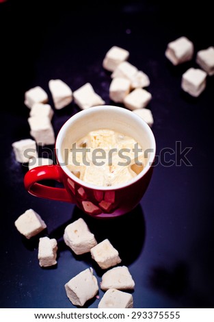 Cup of cacao with marshmallow on a dark background