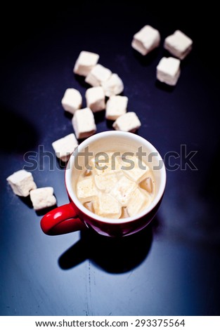 Cup of cacao with marshmallow on a dark background