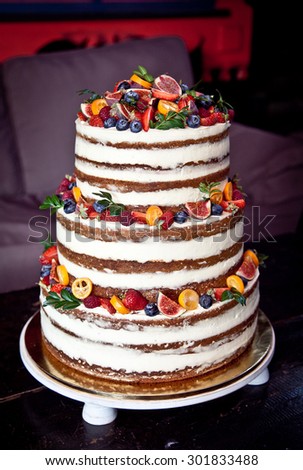 Wedding 3-tier cake with lot of fruits