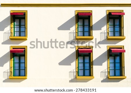 Windows on pastel wall with shadows