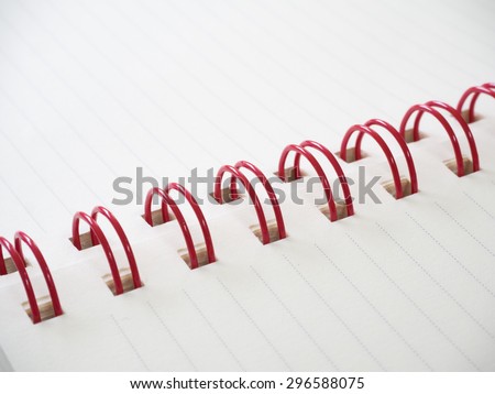 white paper line with red spiral notebook closeup