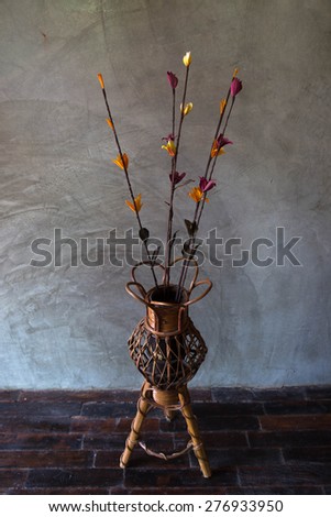 artificial dry flower with the wooden vast, hand made dry flower in the wooden vast style in front of polished cement wall