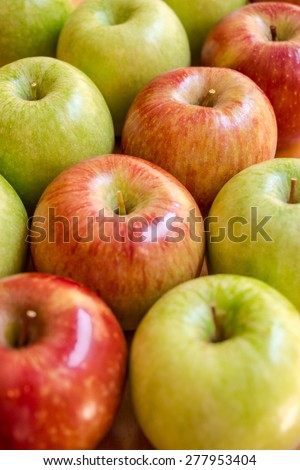 Frame filled with apples , from the lower left corner to the upper right corner is lined diagonal of red apples on the background of green apples. Diagonal of red apples. Vertical shot.