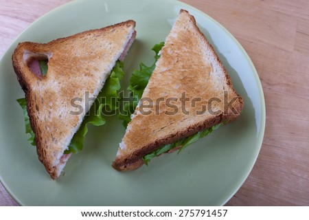 two salad sandwiches on brown toasted bread