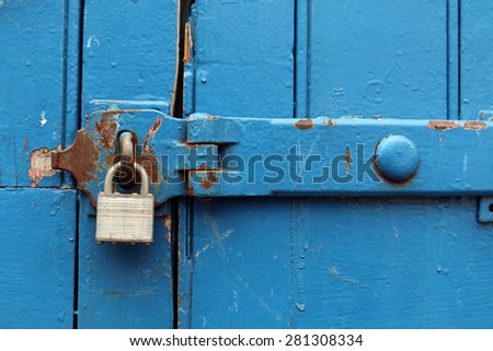 Silver padlock on blue background.