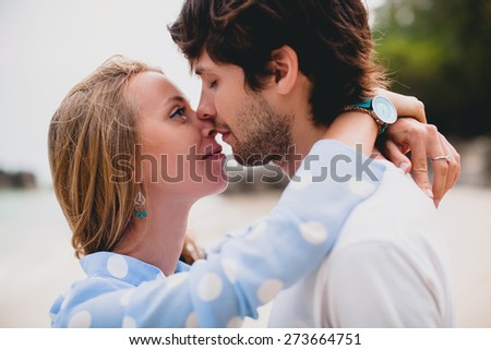 young stylish hipster couple in love on tropical beach during vacation honey moon, embrace, lovely, romance, tenderness, blue dress