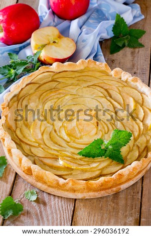 Apple pie, puff pastry pie with custard and jelly on a wooden background