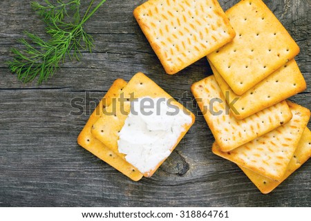 Biscuits salty crackers, dill and cream cheese, top view