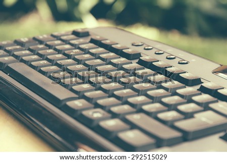 Black computer keyboard in the garden