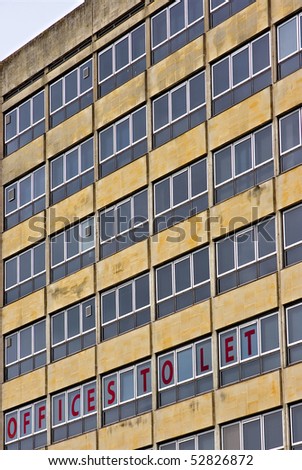 Empty office block with a to let sign in the window