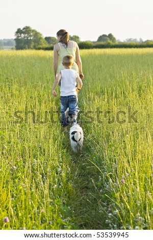A woman and young boy out walking the dog